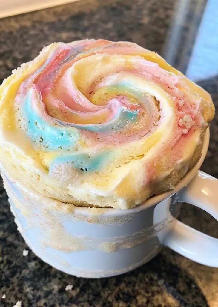 Vanilla Mug Cake Recipe (Soft, Fluffy & Ready in Minutes) 3 Vanilla mug cake recipe with colorful crumb revealed inside the mug